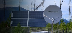 Libra VSAT dish and solar panels in wooded area of the Yukon