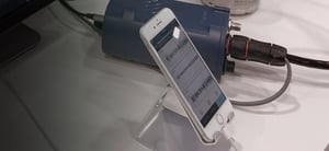 Pegasus digitizer connected via cable to an iphone that is displaying seismic data