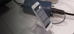 Pegasus digitizer connected via cable to an iphone that is displaying seismic data