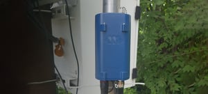 Blue Pegasis digitizer attached to a metal pole in a wooded area