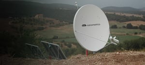 Libra VSAT dish and solar panels installed high on a hill in rural area