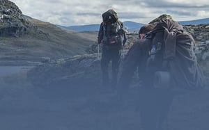 Scientists hiking into mountain area