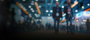 Crowd of people walking around at a conference